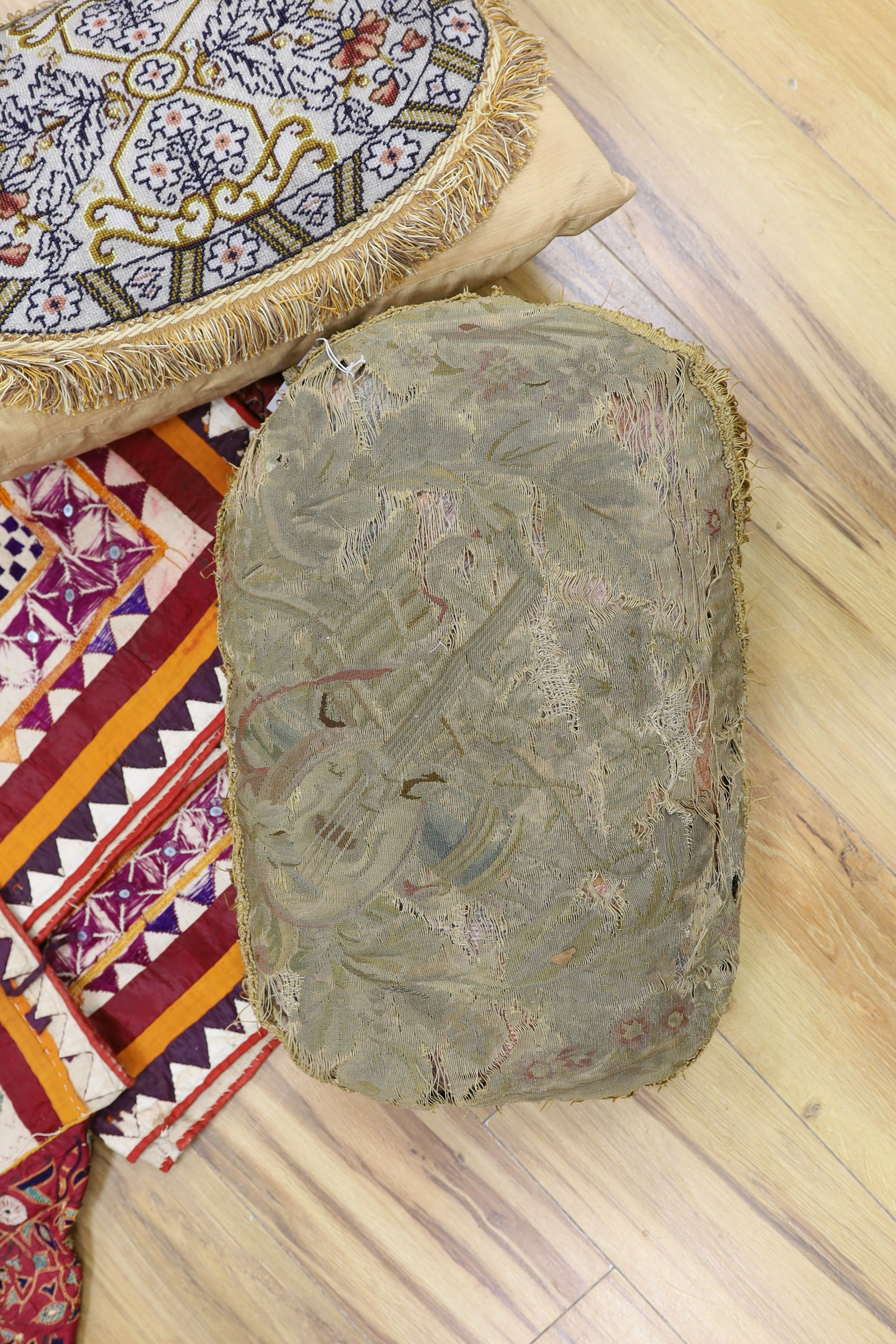 An Indian embroidered cover and cushions